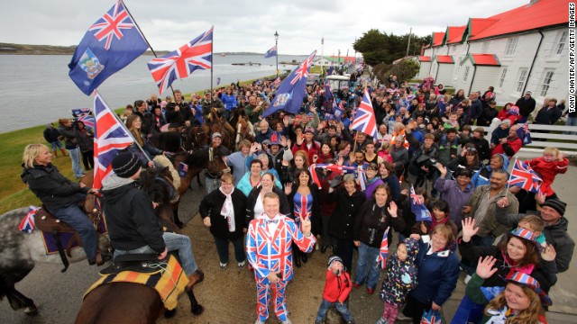 British residents in Falklands wave flags during a protest.