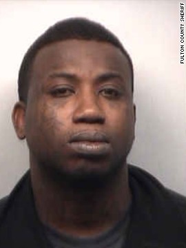 Rapper Gucci Mane turned himself in to authorities on March 26 after a warrant was issued for his arrest on aggravated assault charges in Atlanta.