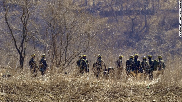South Korean soldiers gather at the foot of a mountain near a military drill field in the border city of Paju on Wednesday, March 27. 
