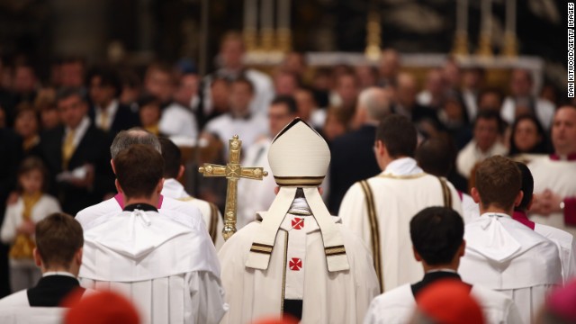 Pope Francis leaves after conducting his first Chrism Mass inside St. Peter's Basilica on Holy Thursday in the Vatican. Francis has been following Christian traditions leading up to Easter during his first Holy Week as pontiff.