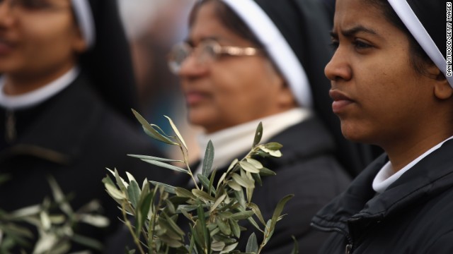 Nuns hold olive leaves on March 24.