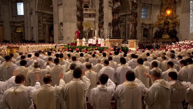 Church leaders signal to the front of the church during the Chrism Mass on Thursday.