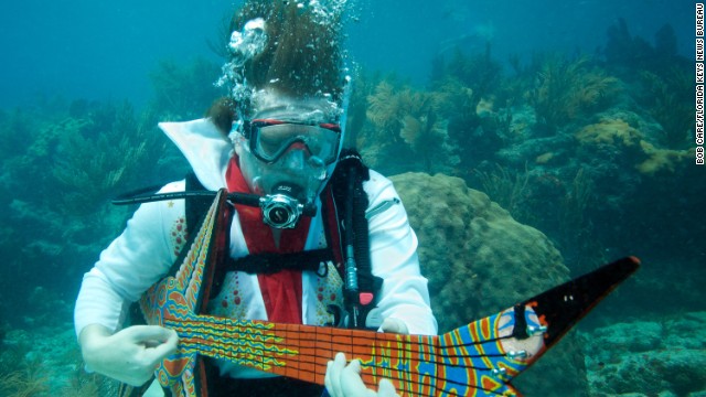 Eric Rolfe, costumed as "Eel-vis Presley" strums on a fake guitar during the Lower Keys Underwater Music Festival in 2011. Check out this year's event in July.