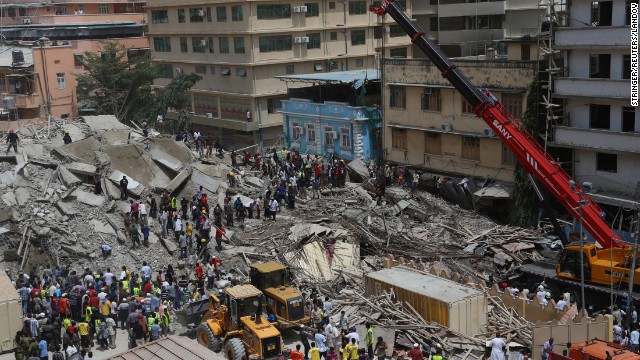 Rescue workers search for survivors as bystanders watch, after a building under construction in the Kariakoo district of central Dar es Salaam, Tanzania, collapsed on March 29.