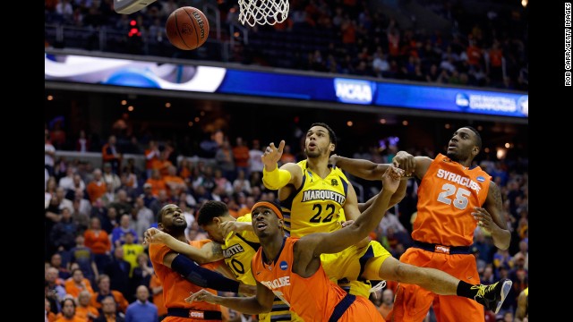 Syracuse and Marquette players fight for the rebound on March 30.