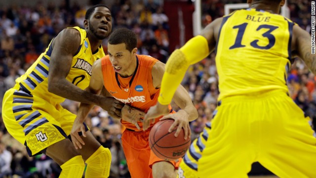 Michael Carter-Williams of Syracuse handles the ball against Jamil Wilson, left, and Vander Blue, right, of Marquette on March 30.