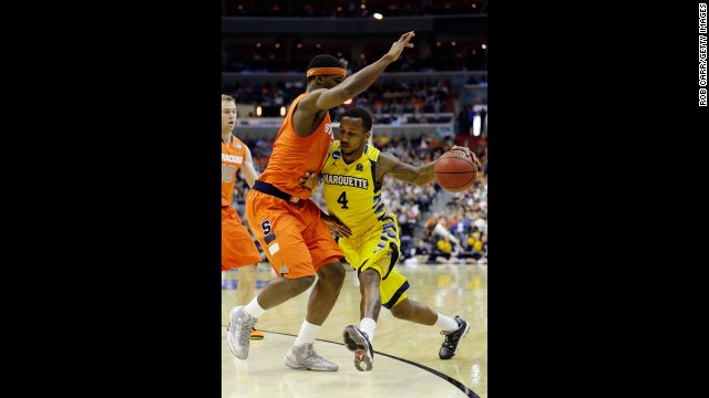 Todd Mayo of Marquette handles the ball against C.J. Fair of Syracuse on March 30.