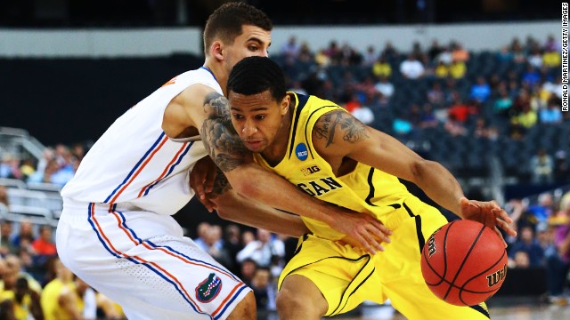 Trey Burke of the Michigan Wolverines, right, drives against Scottie Wilbekin of the Florida Gators on March 31 in Arlington, Texas. Michigan beat Florida with a final score of 79-59.