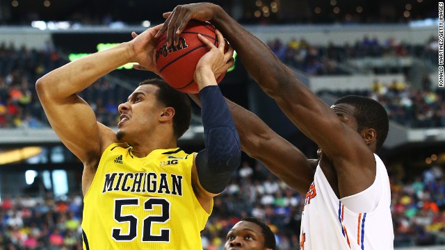 Patric Young of Florida blocks a shot by Jordan Morgan of Michigan.