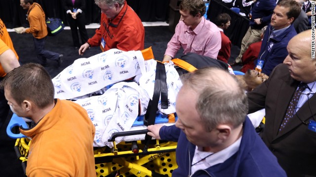 Kevin Ware of the Louisville Cardinals is taken off the court on a backboard after he injured his leg in the first half against the Duke Blue Devils on March 31.