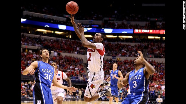 Russ Smith of the Louisville Cardinals drives for a shot attempt against Seth Curry, left, and Tyler Thornton of the Duke Blue Devils on Sunday, March 31, in Indianapolis. Louisville beat Duke 85-63. Check out the action from the fifth round of the 2013 NCAA tournament and look back at the NCAA tournament Sweet 16.