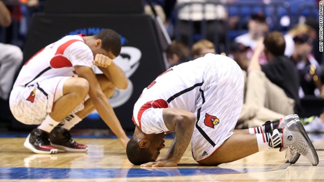 Wayne Blackshear, left, and Chane Behanan of Louisville react after Kevin Ware suffered a compound fracture to his leg in the first half.