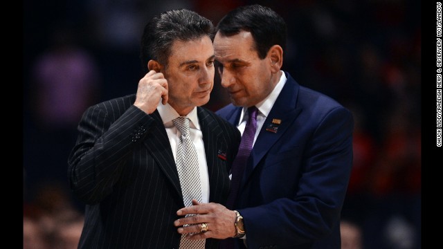 Duke head coach Mike Krzyzewski, right, shares a moment with Louisville head coach Rick Pitino as medical technicians take care of Ware.