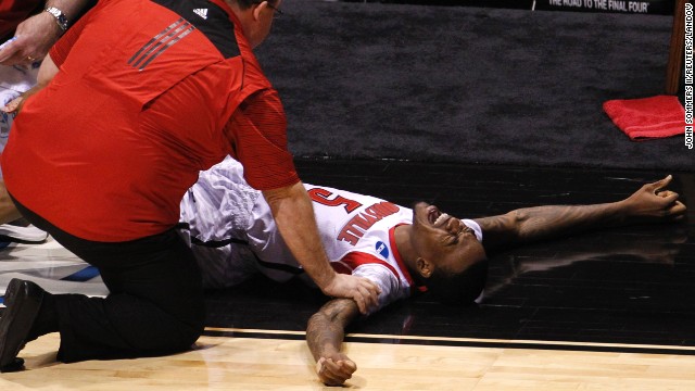 Medical staff tend to Ware after he broke his leg on Sunday, March 31.