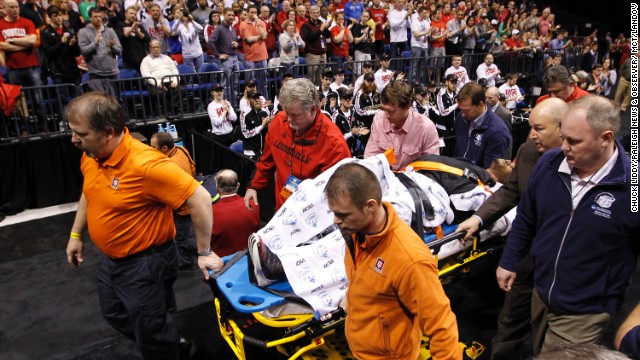 Ware is taken off the court on a stretcher.