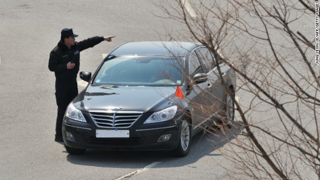 An officer directs a South Korean car that was denied access at a military checkpoint in Paju.