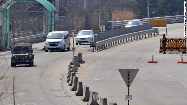 A South Korean military vehicle leads cars arriving from the Kaesong joint industrial park to Paju.