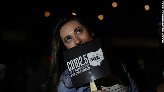 A concertgoer cools off with a CD102.5 fan. The station's staff members say they believe the community is behind them. 