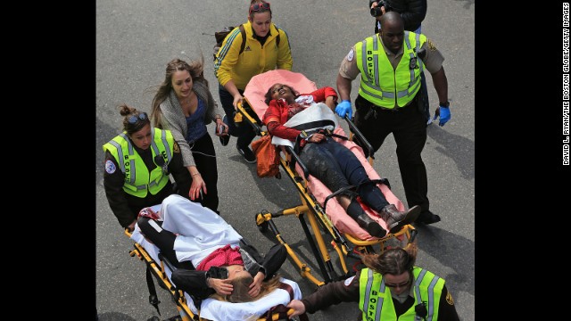 Rescue workers attend to two women injured by the blasts. 