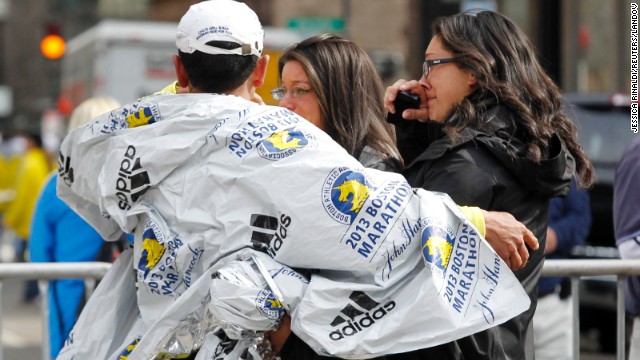 People comfort each near the site of the blasts.