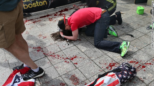 A man comforts a victim on the sidewalk at the scene of the first of two apparent bombings near the finish line of the Boston Marathon on Monday, April 15. <a href='http://www.cnn.com/2013/04/15/us/boston-marathon-explosions/index.html'>Read our developing news story</a> and follow up-to-the-minute reports <a href='http://news.blogs.cnn.com/2013/04/15/explosions-near-finish-of-boston-marathon/'>on CNN.com's This Just In blog</a>.