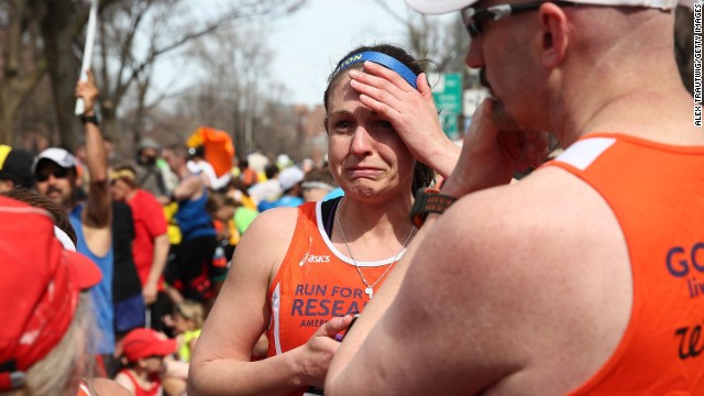 Runners react near Kenmore Square after two successive explosions at the marathon.