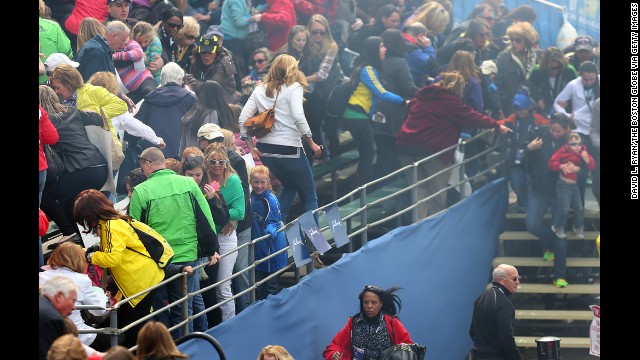 Spectators leave the bleachers after the explosions.