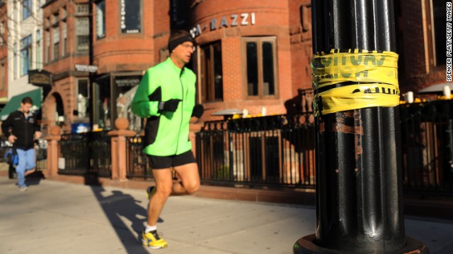 A man jogs down a street near the scene of the bombings on April 16.