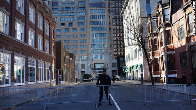 A Boston police officer stands near blast sites April 16.