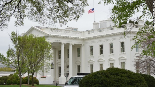 The flag above the White House flies at half staff on Tuesday, April 16 in Washington.