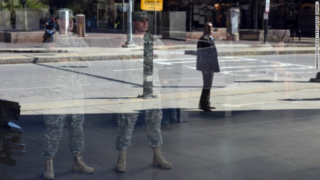 National Guardsmen look out from inside Boston's Back Bay Station on April 16.