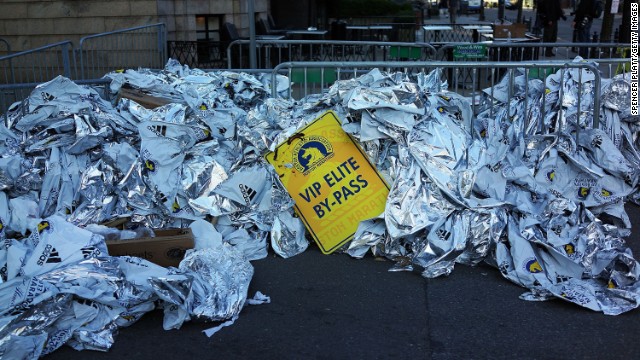 Unused thermal blankets for runners are piled high near the scene of the bombings on April 16.