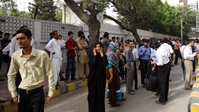 People evacuate buildings in Karachi, Pakistan, following a powerful earthquake near the border with Iran on Tuesday, April 16.