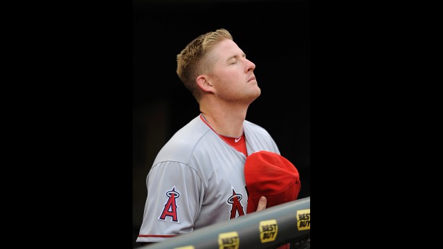 Mark Trumbo of the Los Angeles Angels of Anaheim stands during the National Anthem following a moment of silence to honor the victims of the Boston Marathon bombing before the game against the Minnesota Twins on April 15, 2013 in Minneapolis, Minnesota. See all photography related to the Boston bombings.