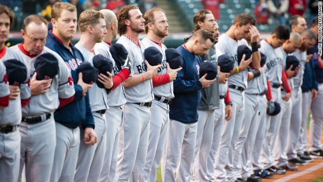 Members of the Boston Red Sox observe a moment of silence before their game against the Cleveland Indians on April 16 in Cleveland. 