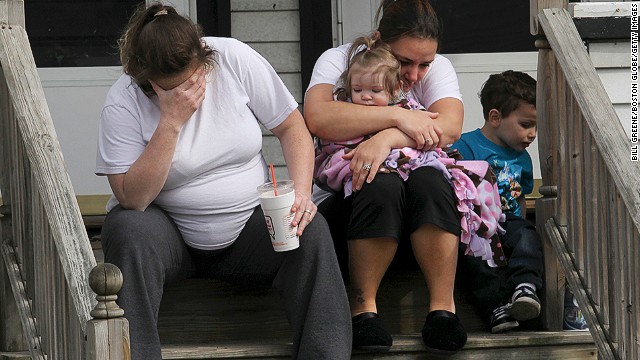 On the shared porch of their home in Medford, Massachusetts, on April 16, Colleen Howe, left, and Lisa O'Leary grieve for their neighbor, Patty Campbell, who lost her daughter Krystle Campbell in the bombings.