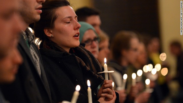 Attendees hold candles in honor of the victims at an interfaith service at Arlington Street Church in Boston on April 16.