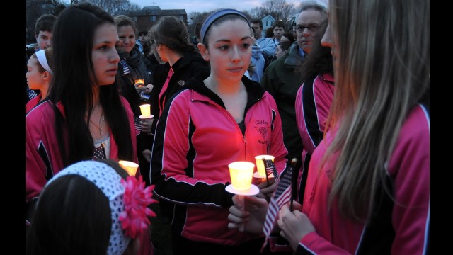 Students from the Clifden Academy hold an American flag and candles during a vigil on April 16 in Dorcester, Massachusetts, in honor of 8-year-old Martin Richard, who was killed in the bombings.