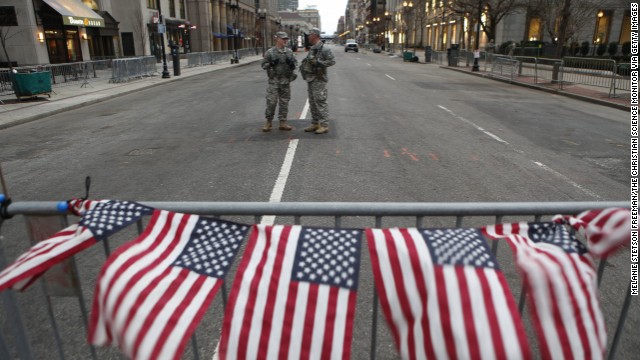 American flags hang from a barrier on April 16 at a roadblock staffed by National Guard soldiers at the end of Boylston Street near the site of the bombings in Boston.