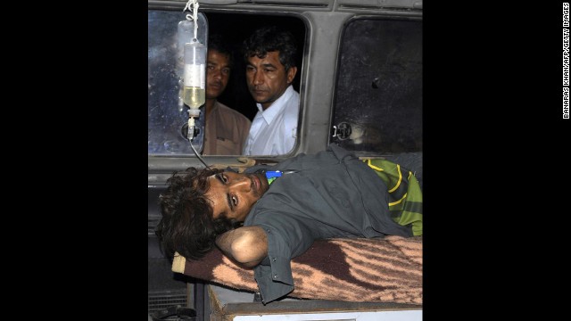 An injured Pakistani man lies in an ambulance outside a hospital in the town of Dalbandin in southwestern Baluchistan province on Wednesday.