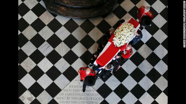 The bearer party, made up of personnel from all three armed services, carry Thatcher's coffin out of St Paul's Cathedral.