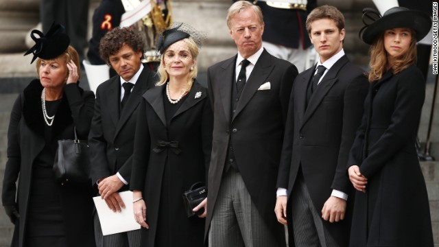 Carol Thatcher, Marco Grass, Sarah Thatcher, Mark Thatcher, Michael Thatcher and Amanda Thatcher watch from the steps of St. Paul's Cathedral as the coffin is placed in the hearse after the funeral.