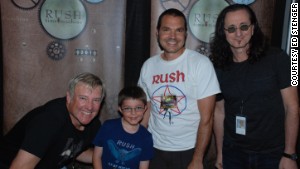 Ed Stenger and his son Zach meet Alex Lifeson, left and Geddy Lee, right, in Toronto, Canada.
