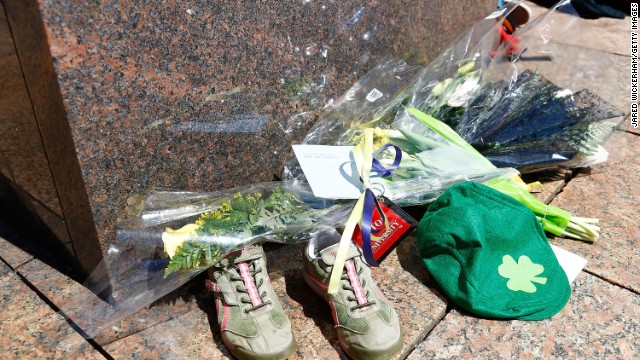 Flowers, running shoes and other items are left in memory of Chinese graduate student Lingzi Lu, who was killed during the bomb explosions on April 17.