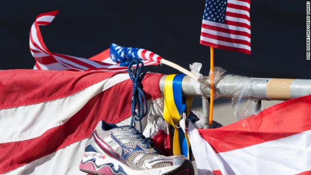 A running shoe and U.S. flag are part of a memorial on the Boston Marathon route on April 18.