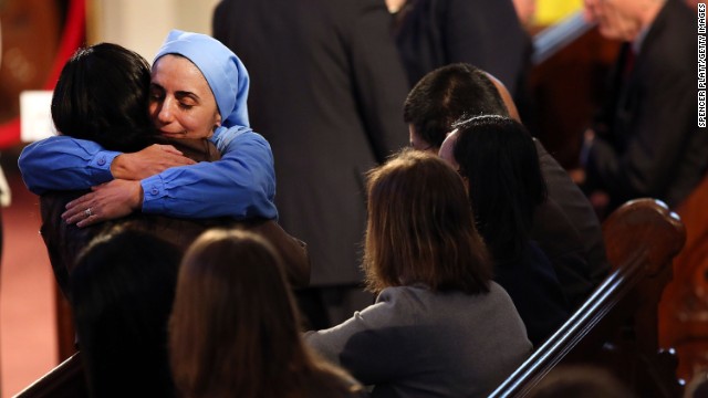 A nun hugs a woman at the interfaith prayer service. 