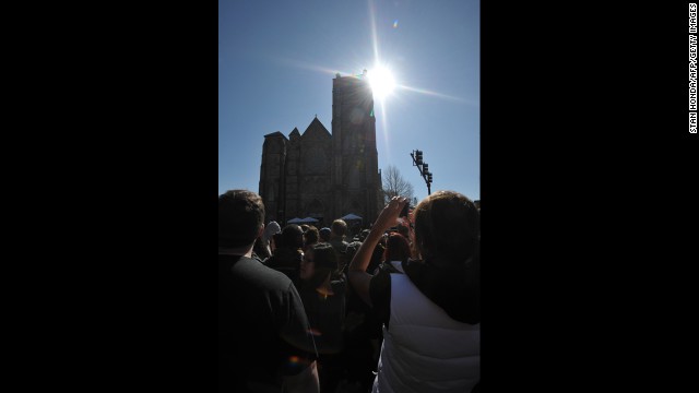 People gather outside of the Cathedral of the Holy Cross.