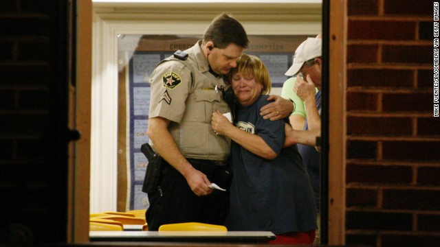 A sheriff's deputy comforts a woman at a command post on April 18.