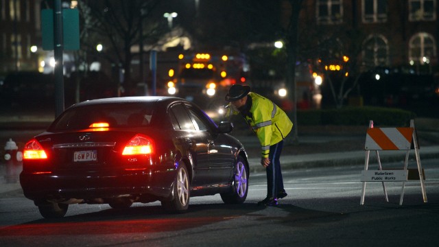 A police officer talks to a driver at a checkpoint in Watertown, Massachusetts. 