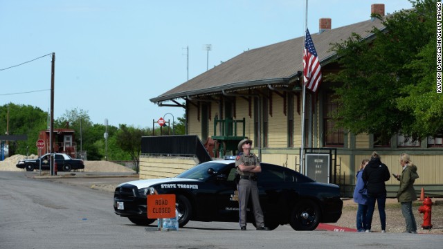 A Texas State Trooper stops people from entering a neighborhood near the plant on April 18.